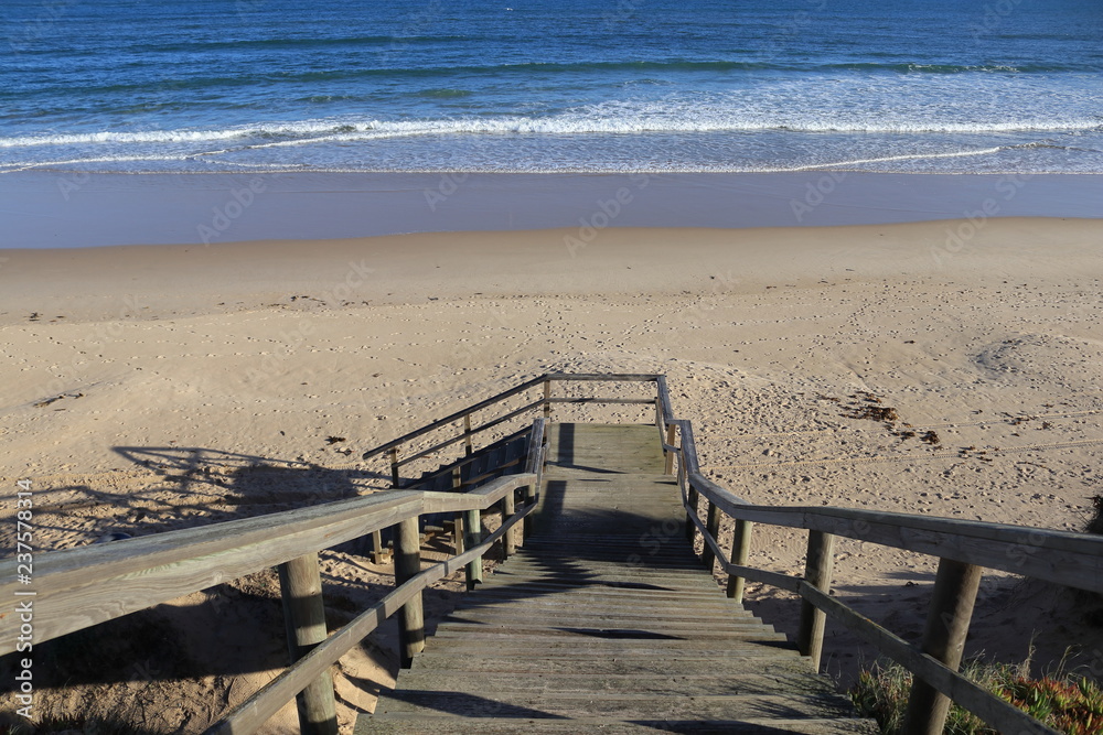wooden staircase for access to the beach with the sea and sand