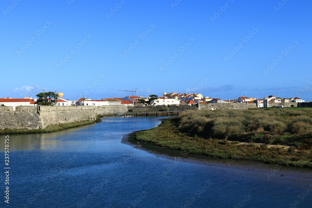 river with blue water and city in the background