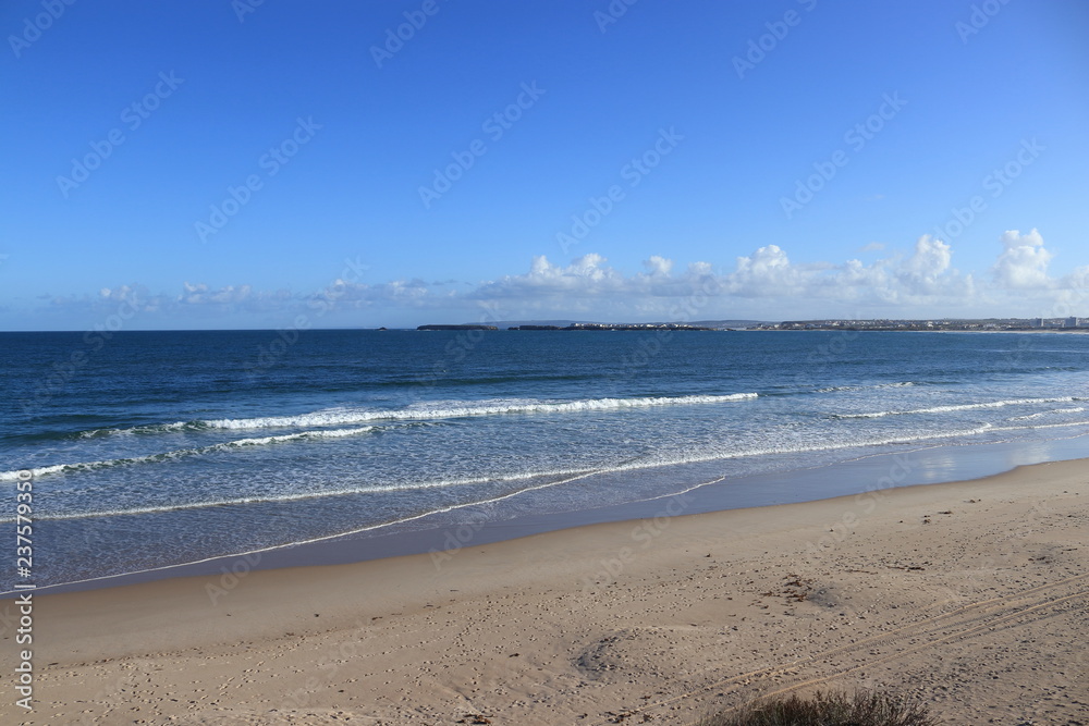 beach of gâmboa in Peniche with sand and cloudy sky in the background