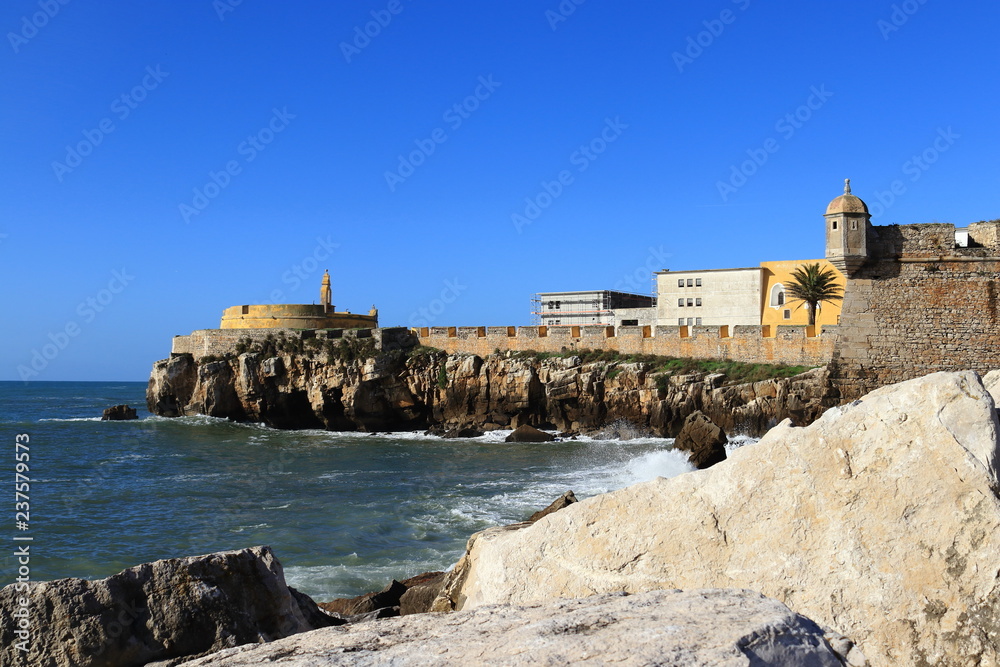 detail of old fort with sea water and rocks in the foreground, Peniche Portugal