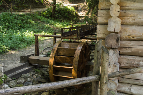 Close up of wooden wheel of water mill