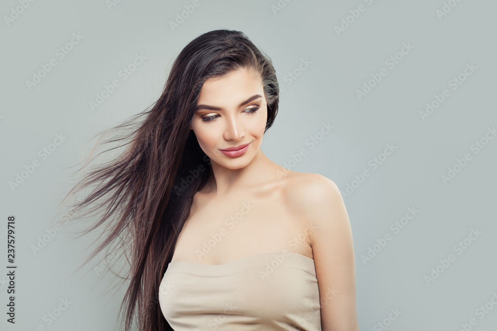 Young beautiful woman with blowing hair looking at background with copy space Young beautiful woman with blowing hair looking at background with copy space