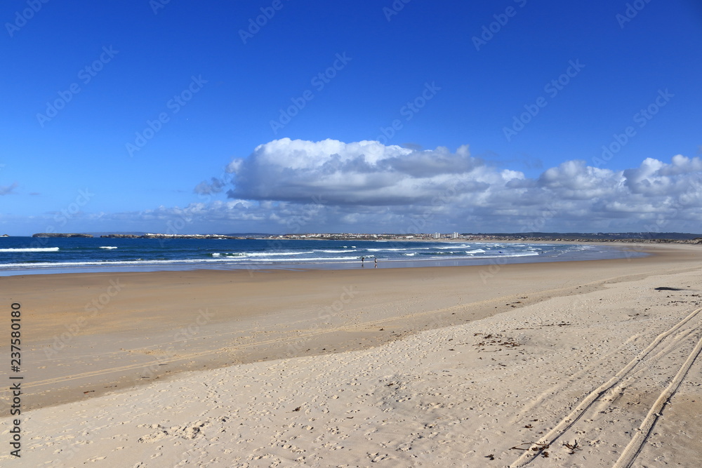 Sand in the foreground, blue sea and cloudy sky in the background Sand in the foreground, blue sea and cloudy sky in the background