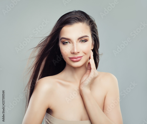 Cheerful brunette girl fashion model with long healthy hair and makeup