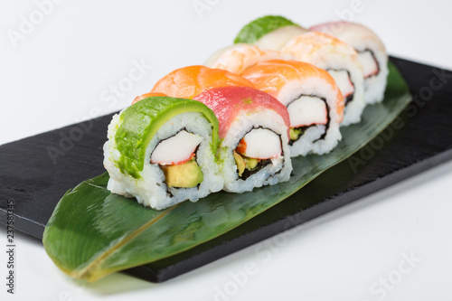 Set of colorful sushi rolls served on leaf