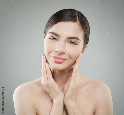 Smiling brunette woman with healthy clear skin