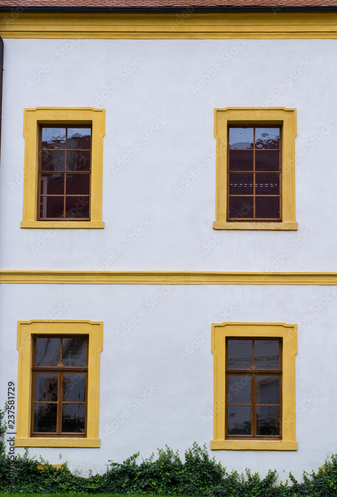 facade of an old german house with wooden windows and white walls