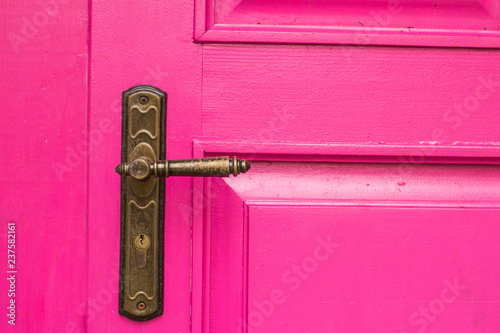 vintage wooden pink door with metal furniture