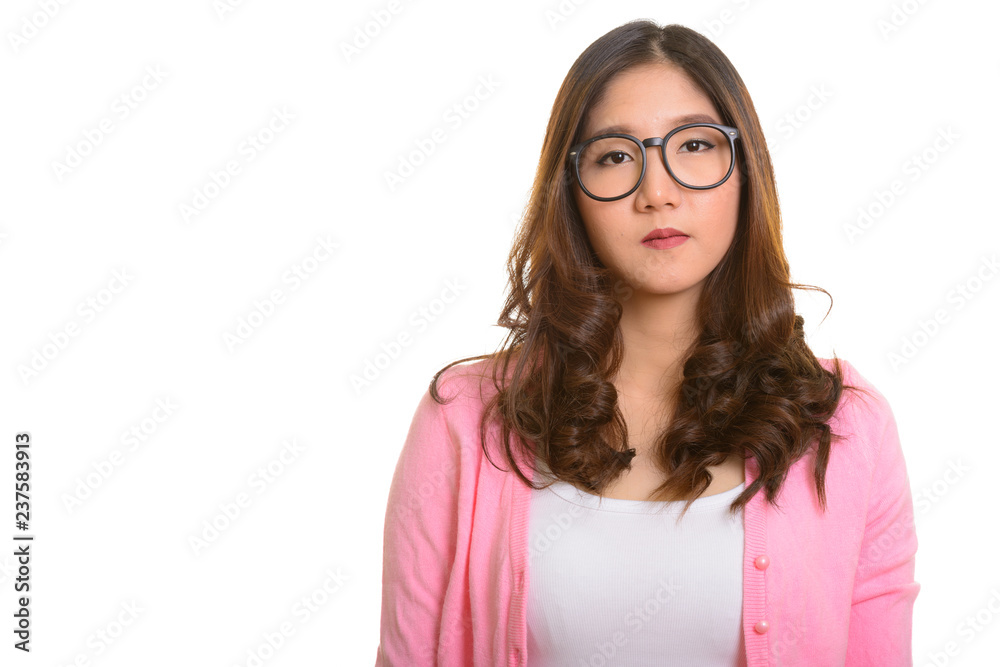 Portrait of young beautiful Asian woman wearing eyeglasses
