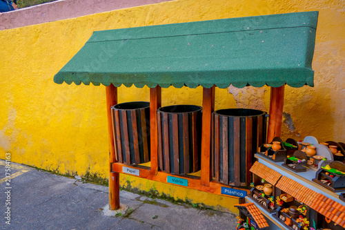 Outdoor view of handycrafts close to a garbage collector in a paper, glass and plastic collector in the Cuicocha lake photo