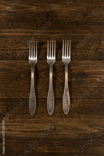 Set of vintage forks on a wooden background