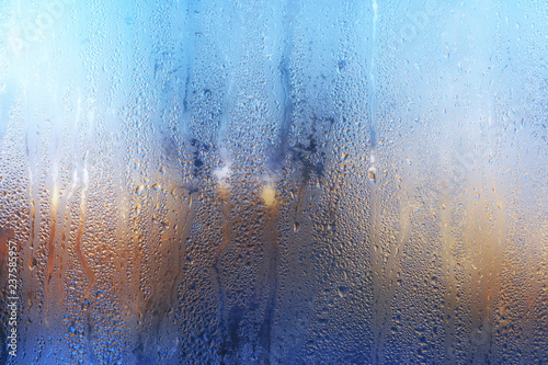 Nature background with frozen water drops on window glass