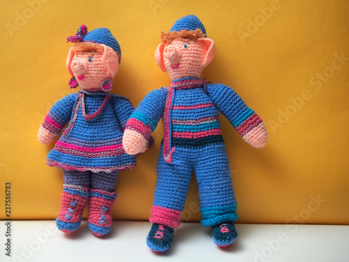 Fotografie, Obraz Two handmade dolls with Christmas decorations. Knitted dolls.