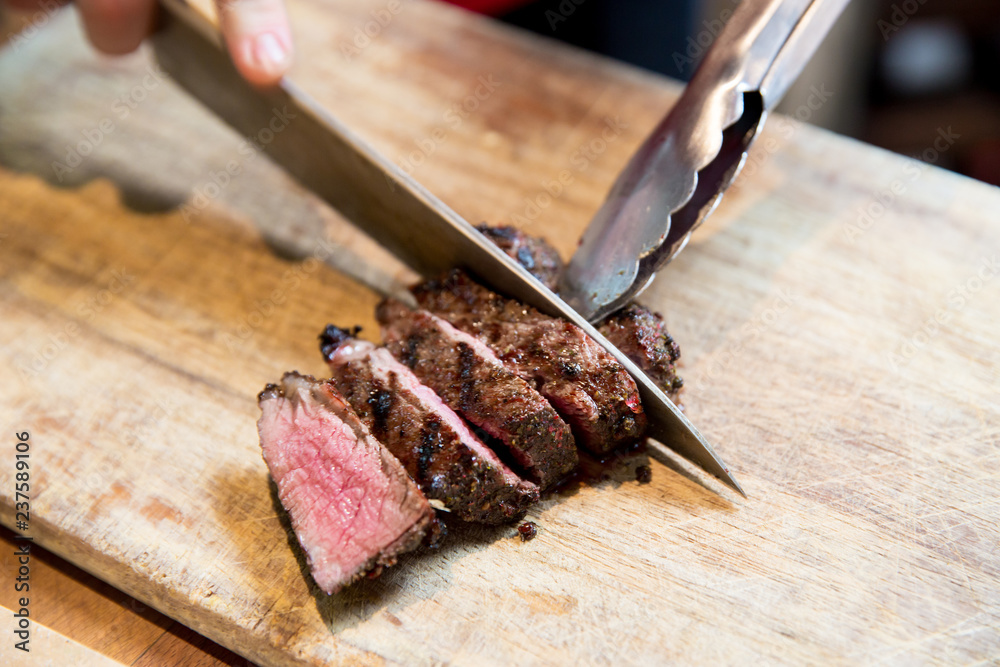 Chopping the beefsteak on Wooden Cutting Board Chopping the beefsteak on Wooden Cutting Board