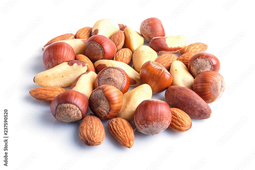 Piles of various nuts isolated on white background. Piles of various nuts isolated on white background.