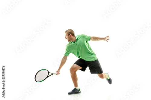The one caucasian man playing tennis isolated on white background. Studio shot of fit young player at studio in motion or movement during sport game..