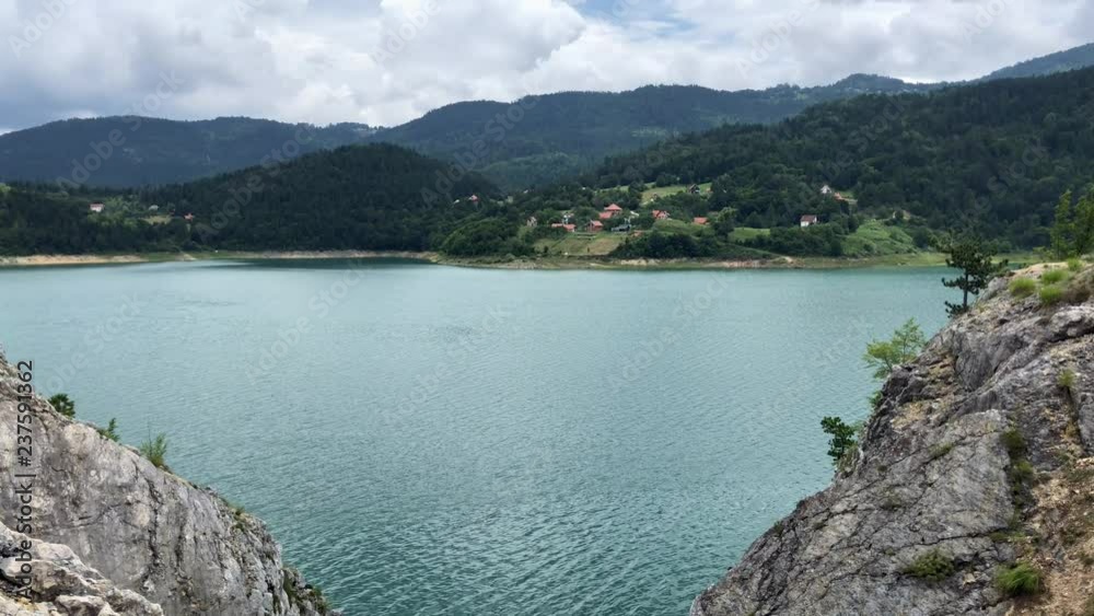 View on Zaovine Lake water and hills in summer cloudy day in Serbia View on Zaovine Lake water and hills in summer cloudy day in Serbia