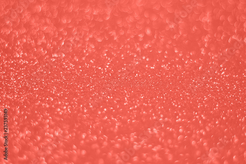 Blurred glitter background living coral color. Color of the year 2019.