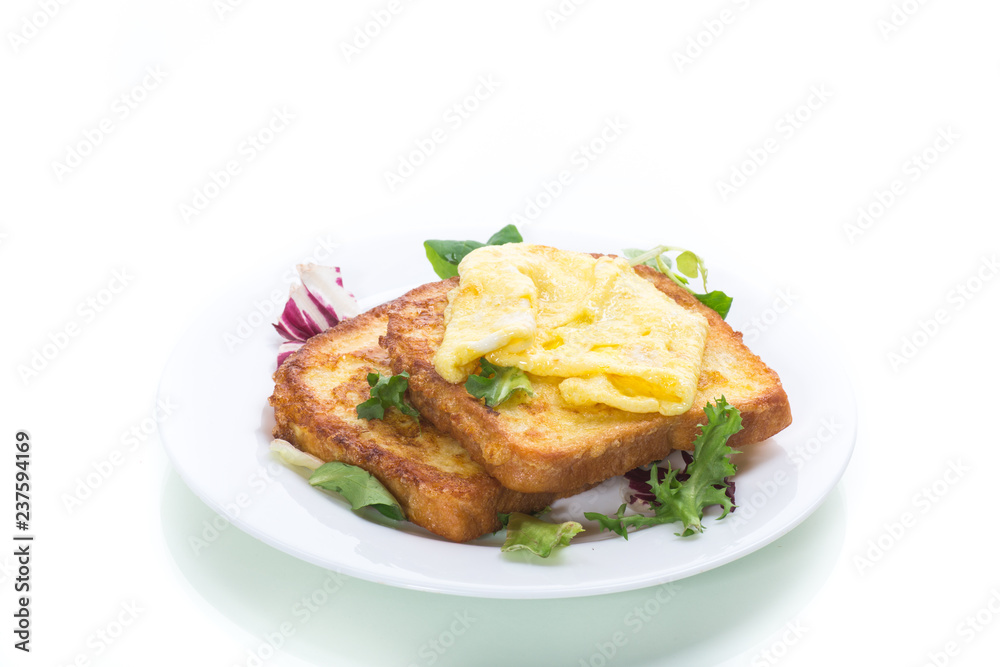 fried croutons in eggs with fried egg in a plate