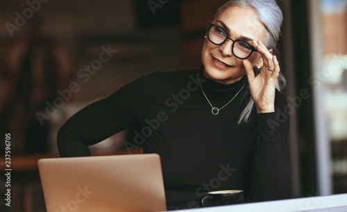 Senior businesswoman thinking at cafe photo