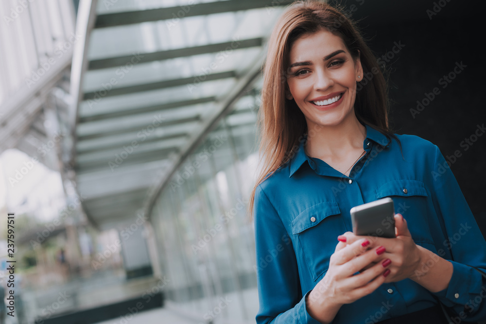 © Yakobchuk Olena - Concept of success and well-being. Waist up portrait of smiling successful lady in stylish cloth staying near business center. Copy space on left © Yakobchuk Olena - Concept of success and well-being. Waist up portrait of smiling successful lady in stylish cloth staying near business center. Copy space on left