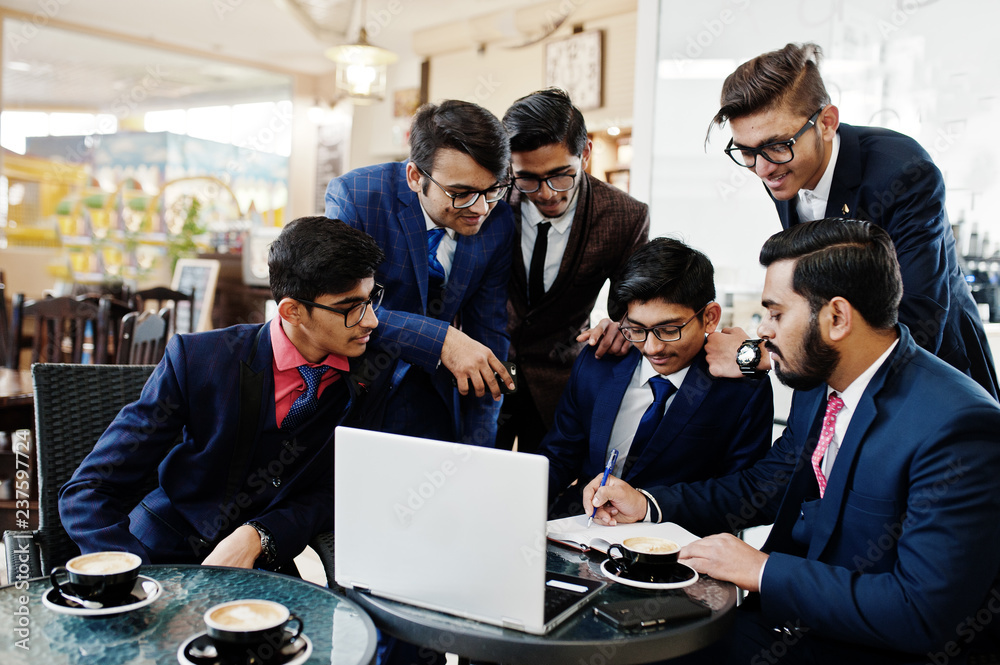 Collaborative process of indian business mans during brainstorming meeting in office.Diverse team of young people dressed in suits cooperating on developing common project. Collaborative process of indian business mans during brainstorming meeting in office.Diverse team of young people dressed in suits cooperating on developing common project.