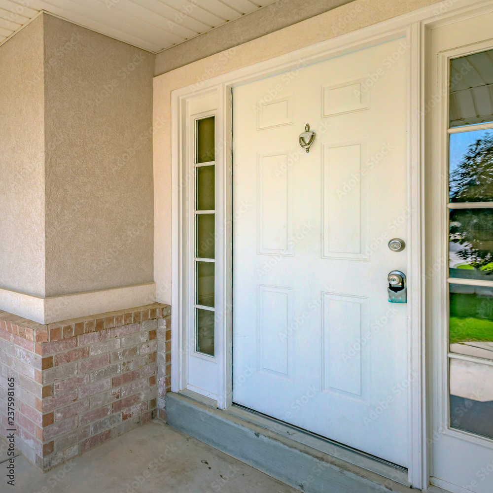 White front door with door knocker and glass panes White front door with door knocker and glass panes