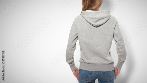 young girl in gray sweatshirt, gray hoodies back view. white background