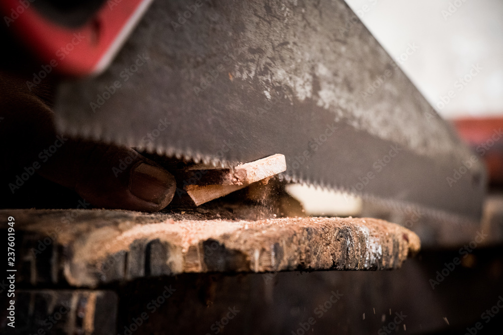 Carpenter working cutting plank with handsaw Carpenter working cutting plank with handsaw