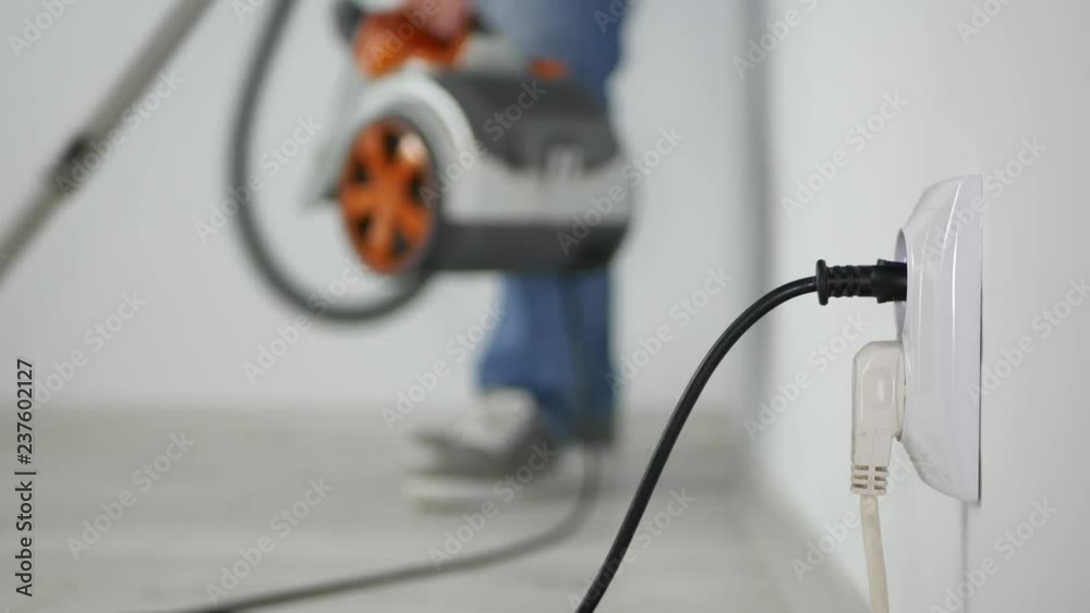 Blurred Image with Man Using a Vacuum Cleaner Cleaning the Floor Inside Room Blurred Image with Man Using a Vacuum Cleaner Cleaning the Floor Inside Room