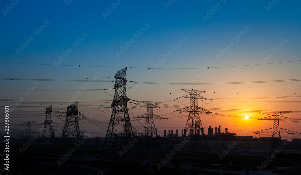 high voltage electricity pole at sunset. energy concept, industrial photo