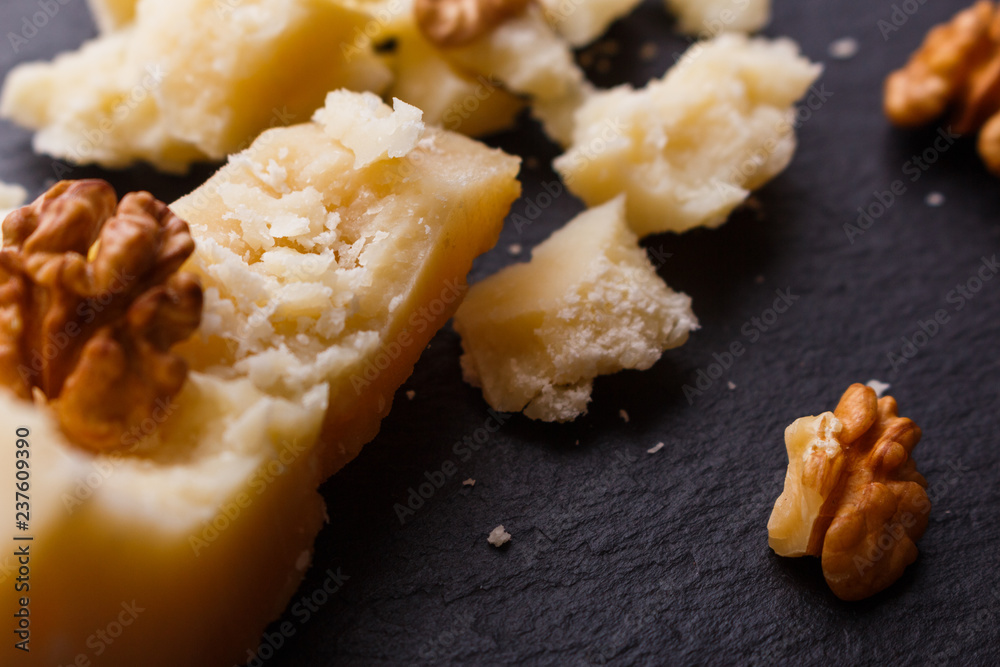 fragrant Parmesan on a slate stone slicing board fragrant Parmesan on a slate stone slicing board