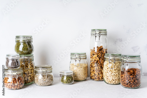 Glass jars with Superfoods nuts and cereals stacked on top of each other