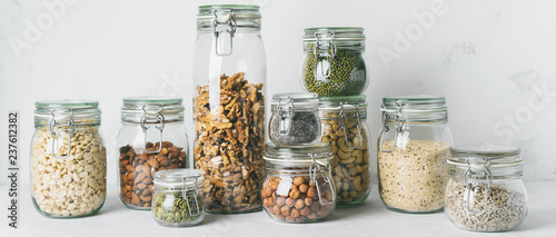 Glass jars with Superfoods nuts and cereals stacked on top of each other