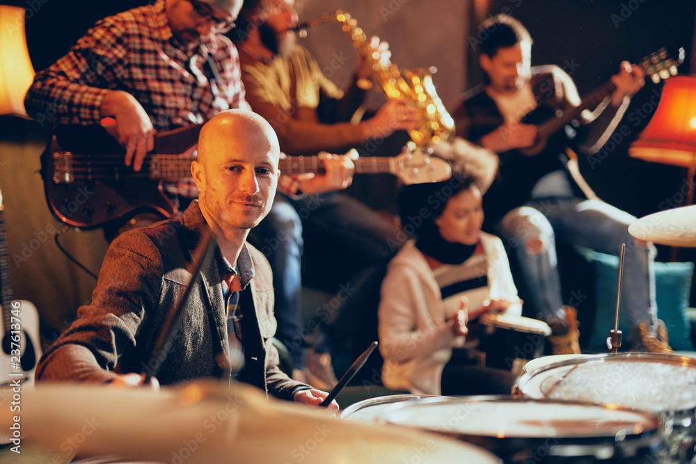 Jazz band playing music in home studio. Selective focus on drummer. Jazz band playing music in home studio. Selective focus on drummer.