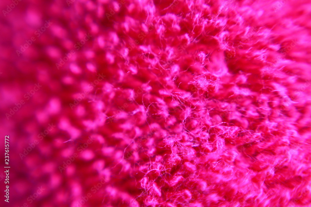 Macro of bright pink fluffy textile texture. Selected focus.  