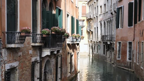 Venice, Italy, Nov 1st, 2018: Classic venetian narrow canal or channel street Romantic gondola ride in Venezia Bright and colorful venice architecture Traditional venetian cityscape amid old buildings