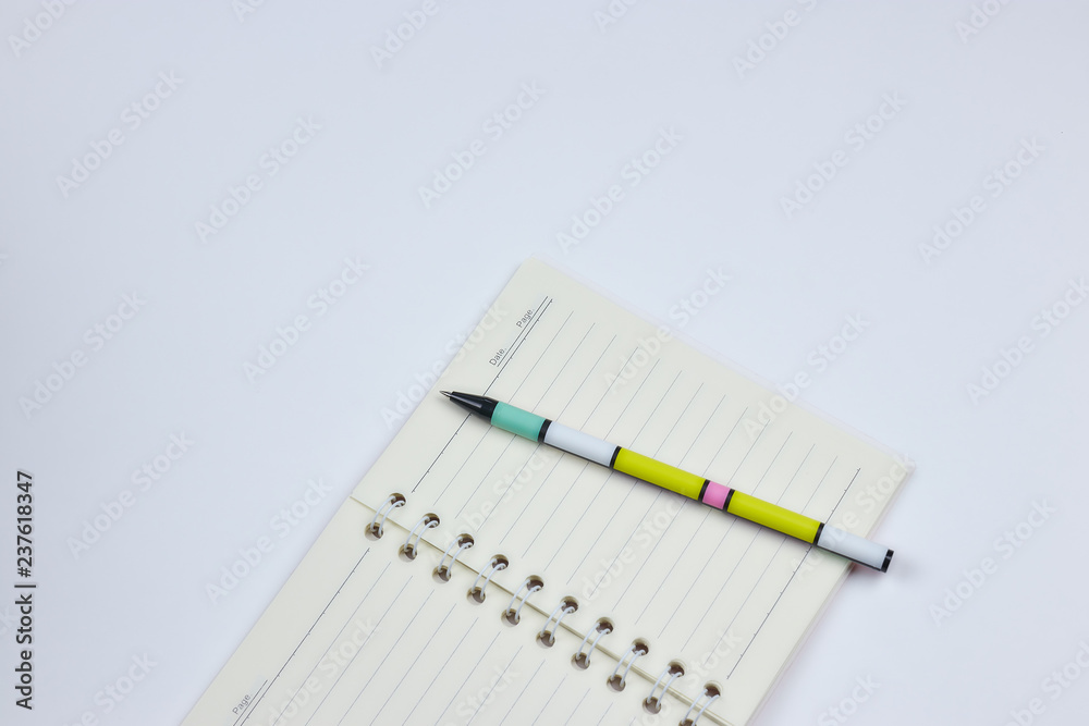 concept of recording your daily affairs. Notebook with pen on a white background. Copy space layout. place for text. view from above. concept of recording your daily affairs. Notebook with pen on a white background. Copy space layout. place for text. view from above.