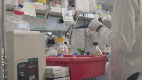 A Scientist Placing Various Equipment in a Lab