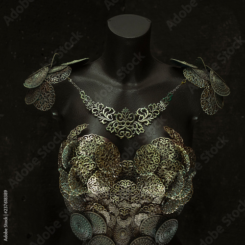 Snake Medusa  creature of Greek mythology. pieces made by hand with goldsmiths and metals such as gold and copper. wears a helmet of green and gold snakes