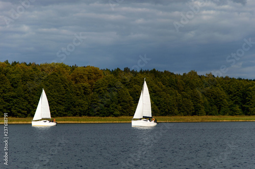 Two sailboats sailing on the Masuria's lakes, Poland