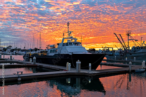 Sunrise with commercial fishing boat at California marina