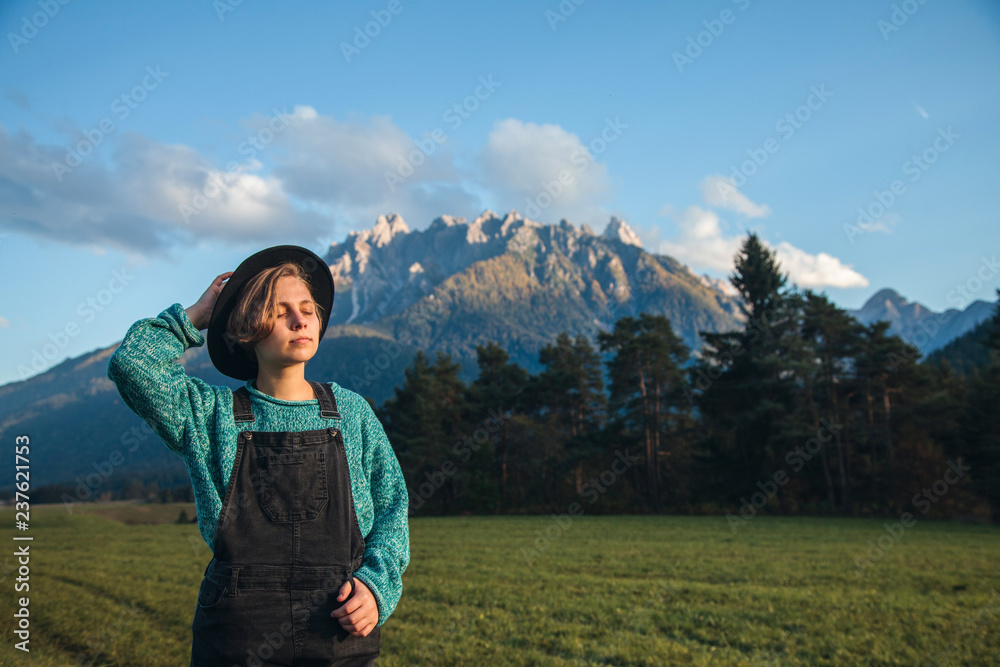 Girl Walks through the Beautiful Meadow Field in Tirol Mountains