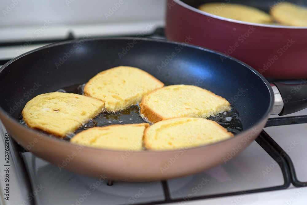 Cooking french toast on frying pan. Close up fried bread in boiling oil on pan. Cooking french toast on frying pan. Close up fried bread in boiling oil on pan.