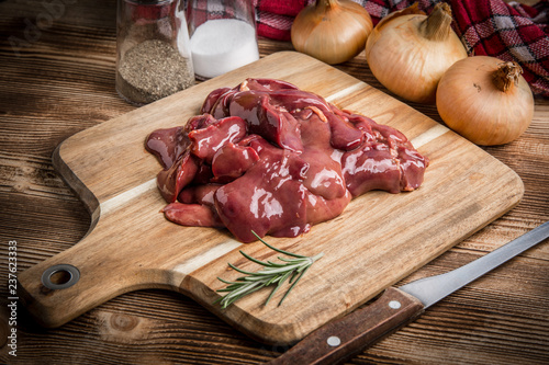 Raw chicken liver on cutting board. photo