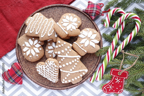 Christmas background. Spiced Gingerbread Cookies with Frosting and Candy Cane