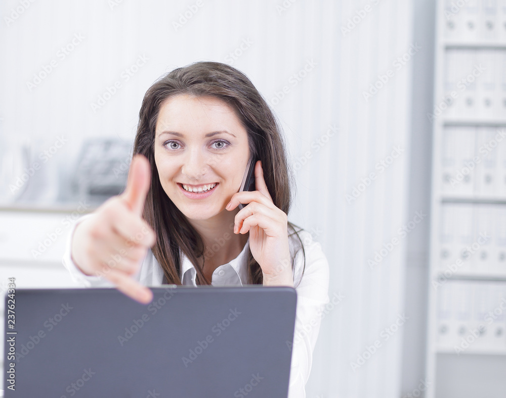 successful business woman showing thumb up in the workplace successful business woman showing thumb up in the workplace