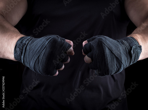 two men's hands wrapped in a black bandage
