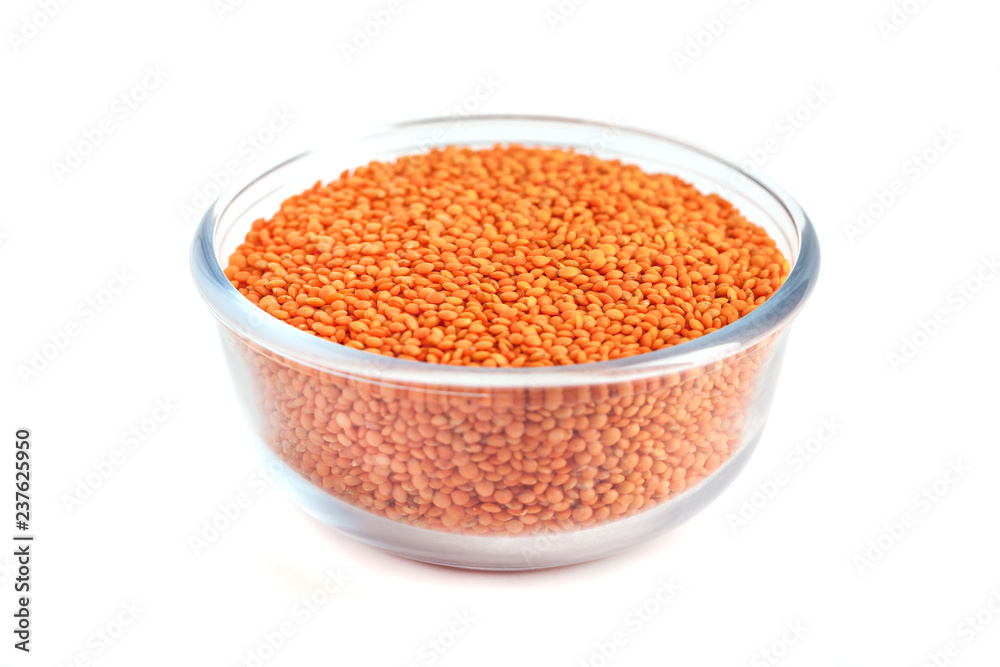 Red lentil in glass bowl isolated on white background Red lentil in glass bowl isolated on white background