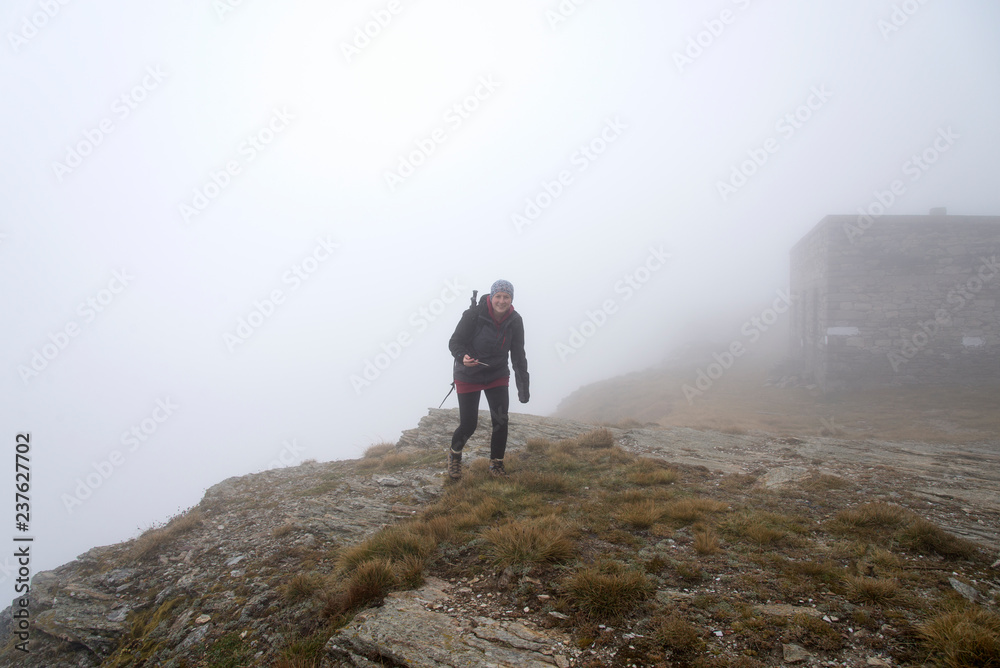 Woman hiking in the fog 